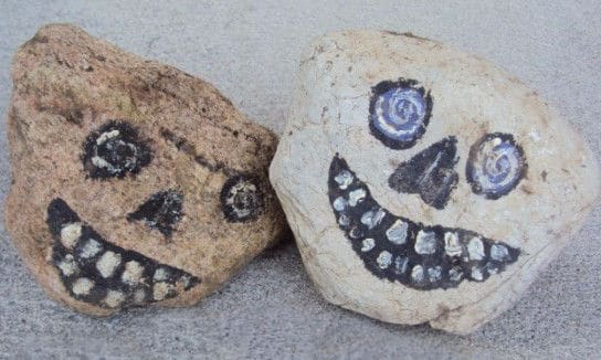 2 Rocks painted to look like skulls on front porch