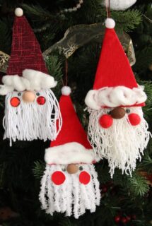 3 cardboard and yarn santa ornaments on Christmas tree