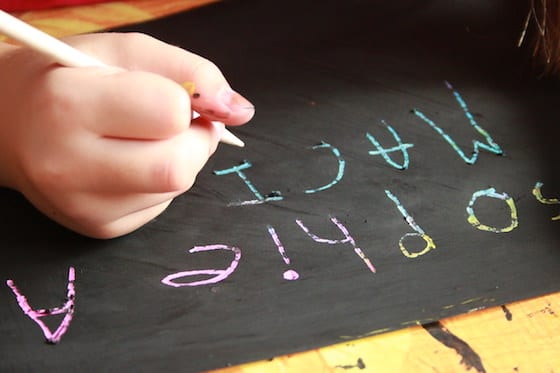 scratching name in blackpaint to reveal colours underneath