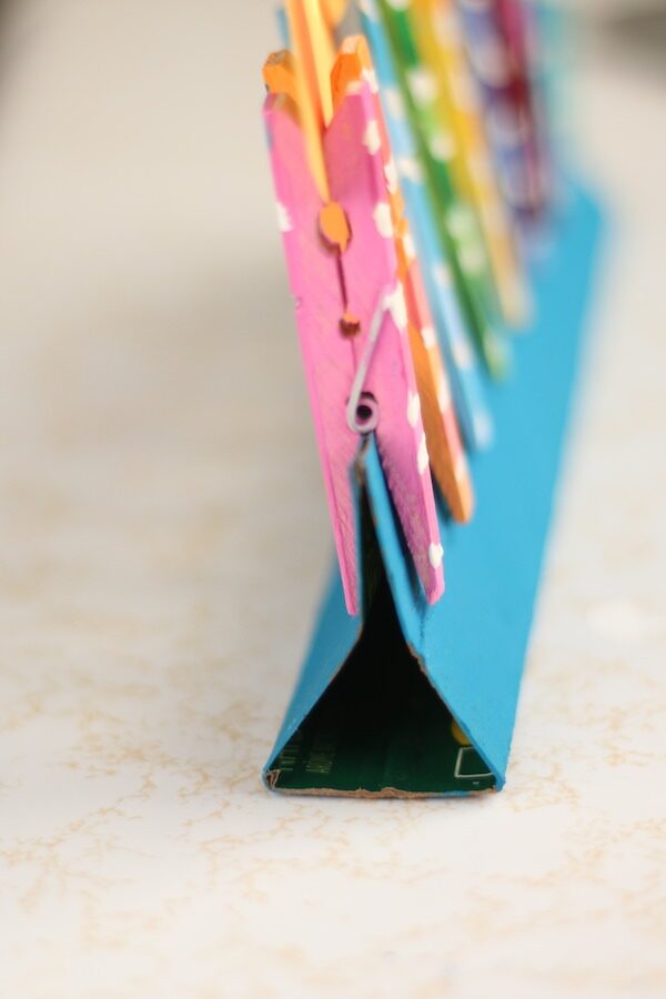 Sideview of folded cardboard menorah