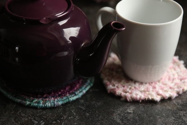 sideview teapot on trivet mug on coaster