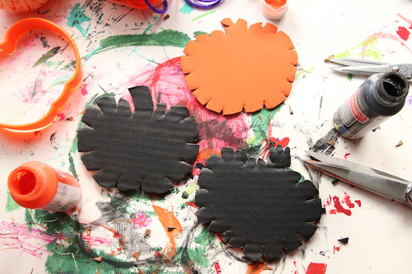 notches cut into painted cardboard pumpkins