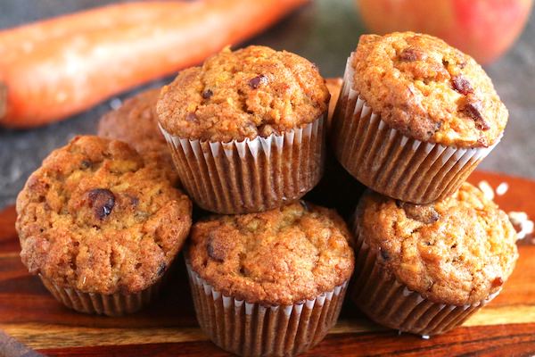 pile of carrot and apple muffins on cutting board