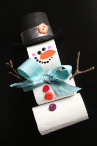 stacked cardboard roll snowman craft black background