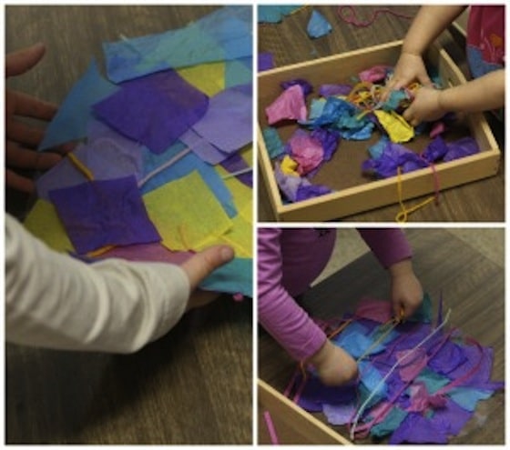 toddlers making easter egg collage with contact paper and tissue paper 