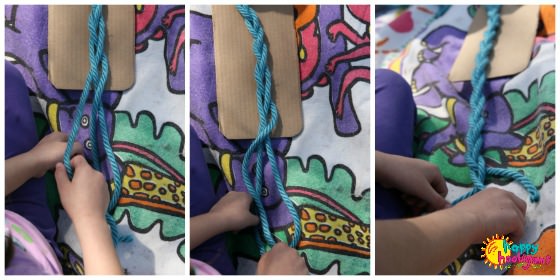 child learning to braid with strands of yarn 