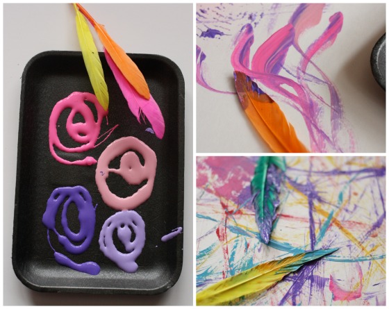 toddler painting with feathers