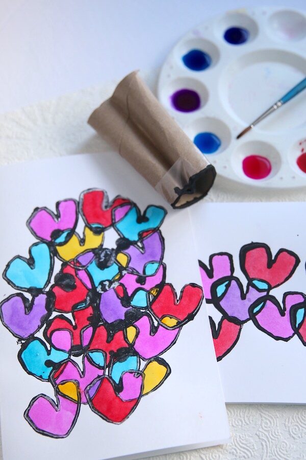 watercolour paints, yardstick, toilet paper roll shaped into heart