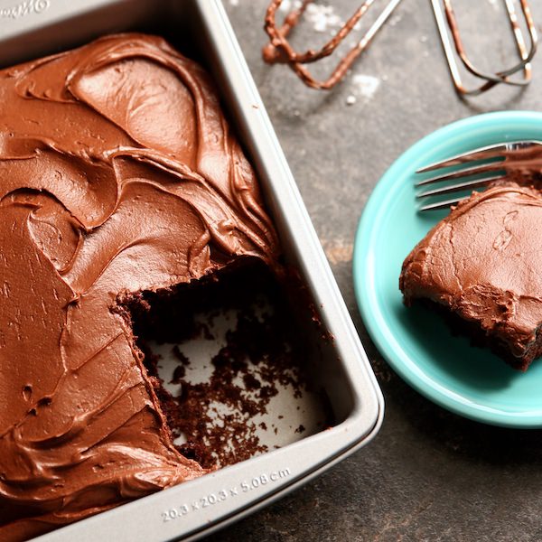 Frosted Chocolate cake in pan with missing slice 