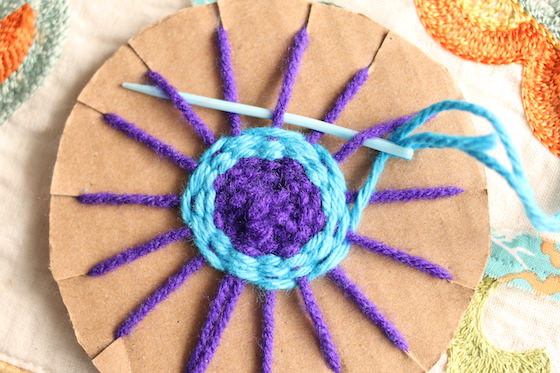 Weaving - purple and blue yarn on a cardboard loom