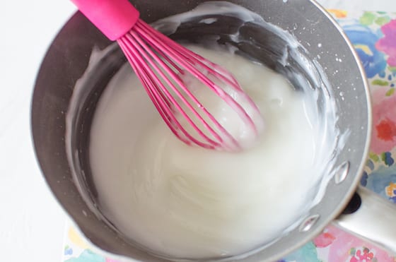 whisking homemade glue ingredients in pot