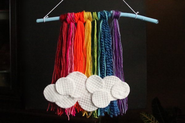 Rainbow yarn and stick wall art