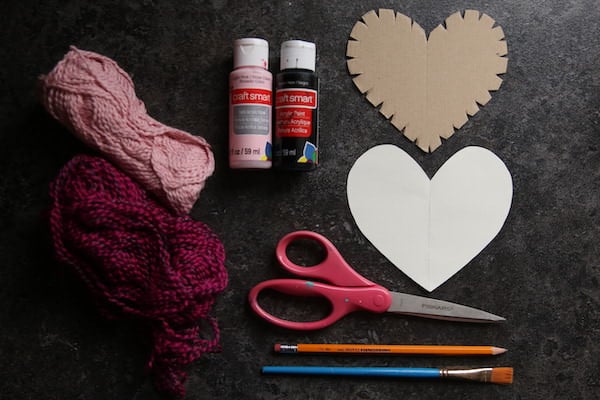 Cardboard heart, paint, yarn, scissors 
